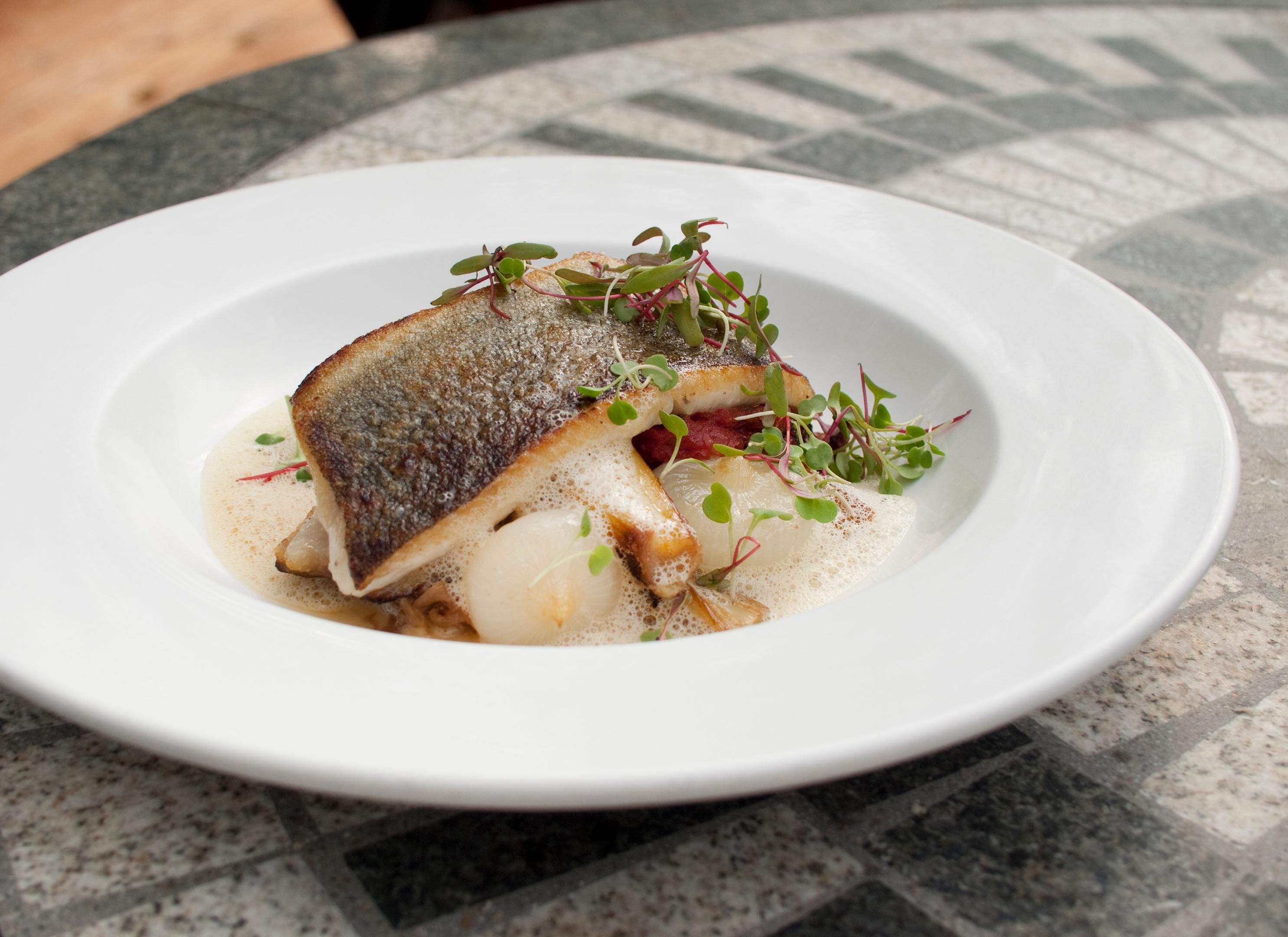 pan seared rainbow trout with braised savoy cabbage, roasted leeks and mustard fumet