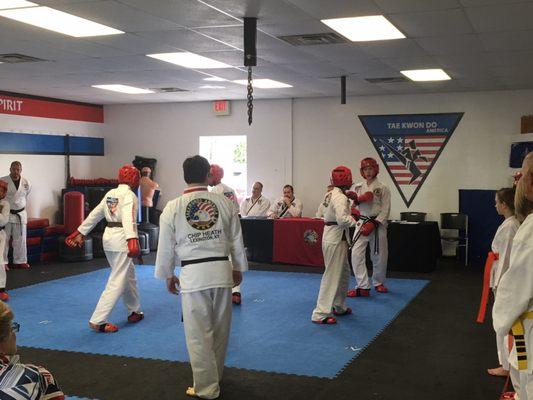 A group earning their belts at a belt test.