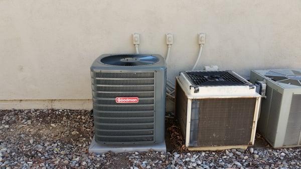 Our new condenser next to the neighbors old junk.