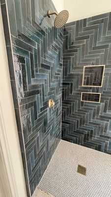 After on our master bathroom remodel. Almost completed. LOVE the tile design with gold accents.