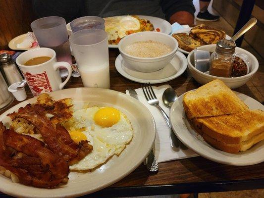 Sausage skillet, Sunnyside up eggs with potatoes and bacon, toast and oatmeal special