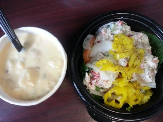 Loaded baked potato soup and seafood salad with hot peppers, onions and tomato on a bed of spinach.