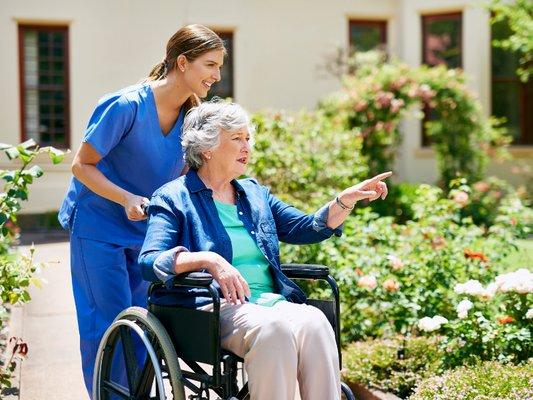 Amy's Eden caregiver enjoying our assisted home yard with a resident.