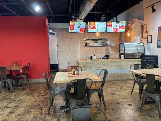 dining room & counter - few other tables to the left along with a long "NY" counter with stools.