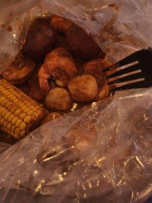 Scallops, shrimp, 2 small potatoes and 1 corn on the cob