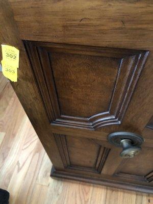 Bent brass knob on antique vintage buffet.