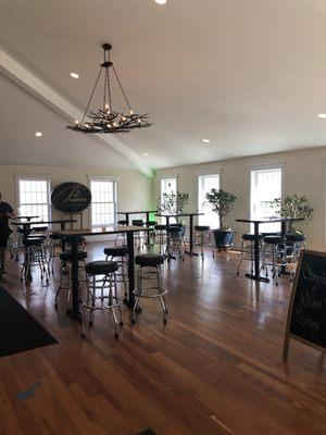 Pretty and open indoor tasting room with high top seating