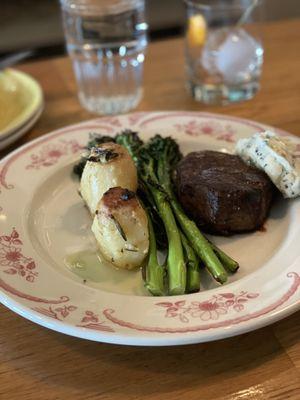 Petit filet with black truffle butter, fondant potatoes and charred broccolini