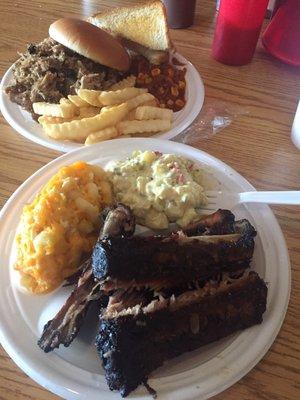 Rib plate with Mac and Cheese, Potato Salad, other plate is Chopped Pork, French Fries and Brunswick Stew