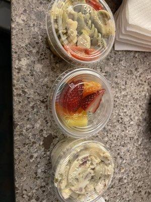 tiny sides of pasta salad, fruit salad, and potato salad