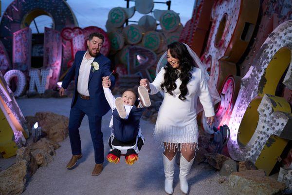 Bride and Groom playing with their son at the Neon Museum.