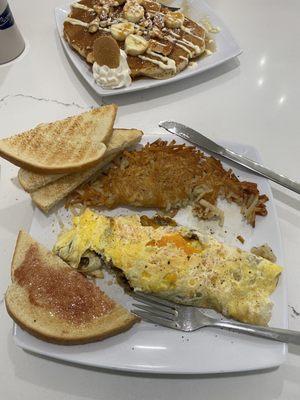 Basic omelet with cheese and meat (cheddar and sausage). Hash browns and sourdough toast.