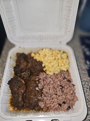 Brown stew chicken, mac & cheese ,rice & peas