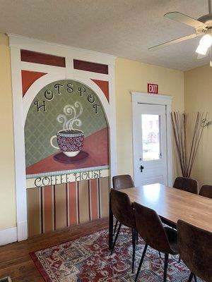 Cute art on the wall in the house converted into the Hot Spot Coffee shop