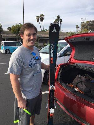 He is very pleased with his new skis.