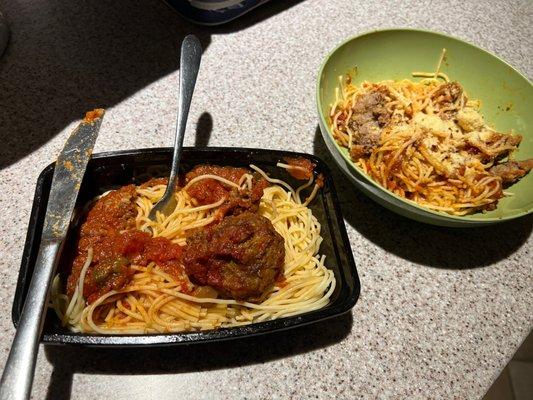 Spaghetti with one meatball on the left. On the right, in the bowl, is spaghetti with half of the sauce and a cut up meatball.