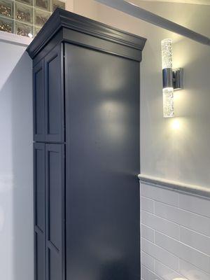 Linen closet/cabinet with a laundry chute in the bottom