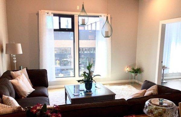 Relax in a cozy sectional while getting to watch the busy street below! Such a bright beautiful space..