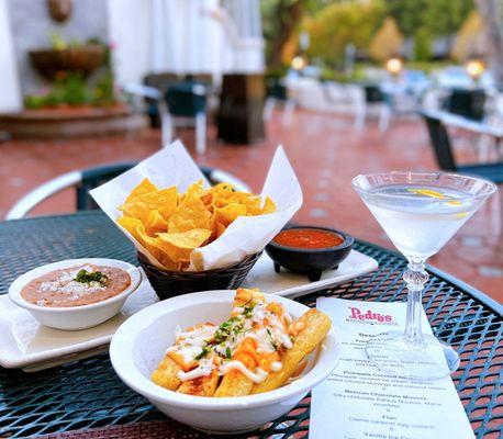 Chips, Salsa, and Bean Dip ($5), Fried Yucca ($8), Goose Martini w/ lemon twist ($13.50). Dog-friendly patio.