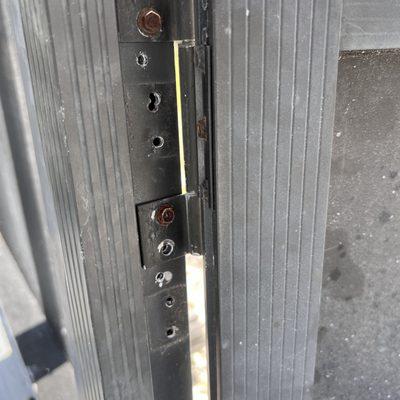 Screen door hinge redrilled multiple times