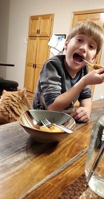 My son enjoying the Cheese pull of the Curds