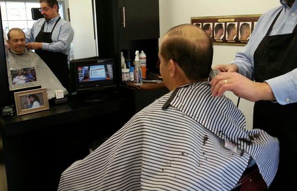 Watch the game while getting your hair cut!