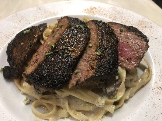 Blackened Steak "Faux-Fredo" Seared steak, served on a bed of fettuccine, tossed in a buttermilk blue cheese "Alfredo"