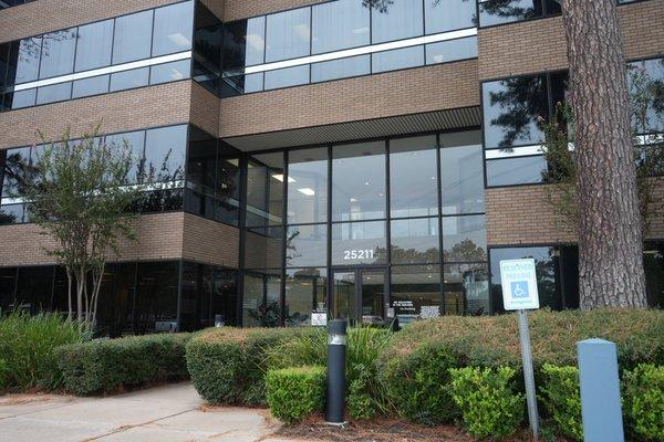 Our Texas Law Office in The Woodlands boasts a sleek and modern facade, featuring large glass windows and a welcoming entrance.