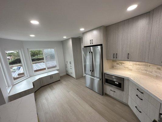 Kitchen remodeling, build bench for nook area, new windows, hardwood floor adding Led recessed lights and paint.