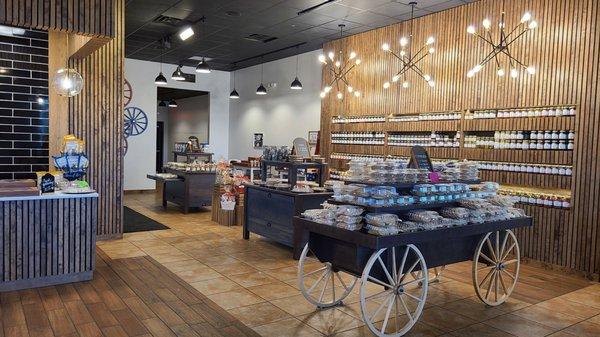 Pies, cookies, cinnamon rolls on wagon and tables plus salsa on the wall