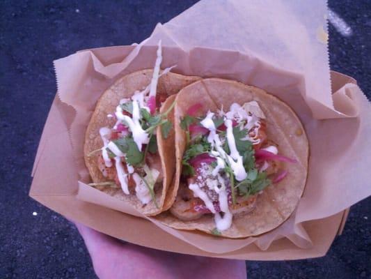 Delicious seasoned shrimp tacos with cilantro, pickled onion,  salsa, cotija, and lime crema.