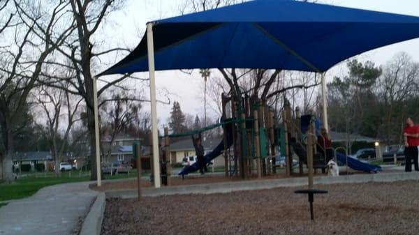 Play area with shade canopy for those hot summer days!