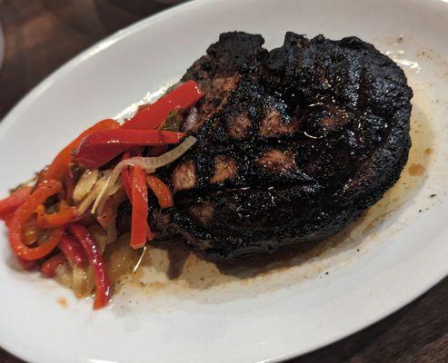 An over-charred and over-cooked pork chop.