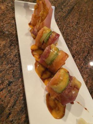 Bingo Bango Roll shrimp tempura spicy tuna top with tuna salmon avocado wrapped with soy paper eel sauce.sweet chilli sauce