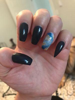 It's a dark blue nail polish with a marble like design.