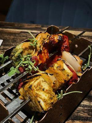 Smoked Trio of Paneer, Chicken, and Shrimp Kebabs with Pickled Peppers, Onions, and smothered in Cashew Sauce.