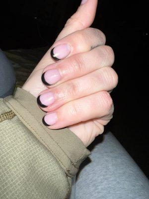 Gel manicure. Asked for a very light pink with black tips. Assignment understood