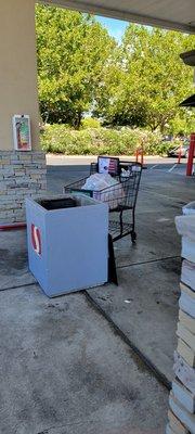 Using a shopping cart to throw away the trash. Hopfully they clean it