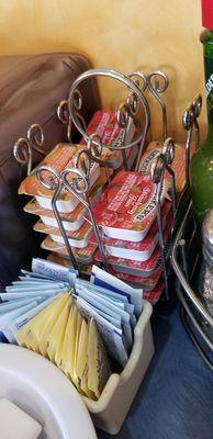 Selection of sweeteners and jelly at the table