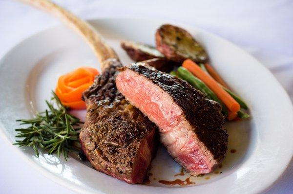 -Omaha Tomahawk Ribeye Steak- 30 oz. Prime "long" bone-in ribeye grilled to perfection topped with sage infused butter.