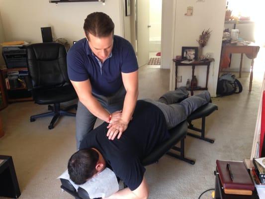 Giving a patient a mid/upper back adjustment.