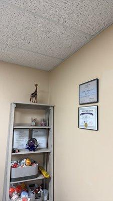 Corner by front desk with certificates