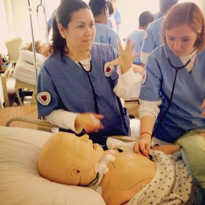 RN students learning nursing skills in the simulation lab.