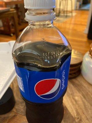 Damaged bottle of Pepsi