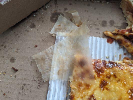 This greasy mess with some sort of parchment paper that spent forever peeling off the back of the crust.   Will not order again. Yuck.