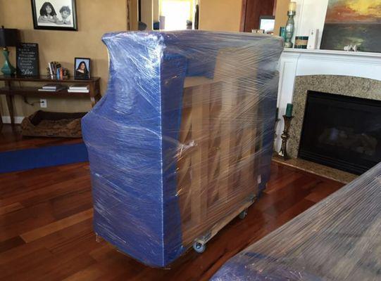 Professionally wrapped upright Piano ready to be moved!