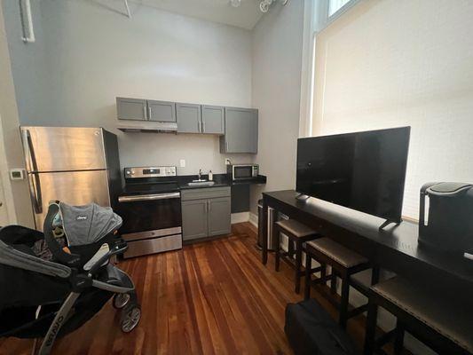 A nice kitchen and big tv.