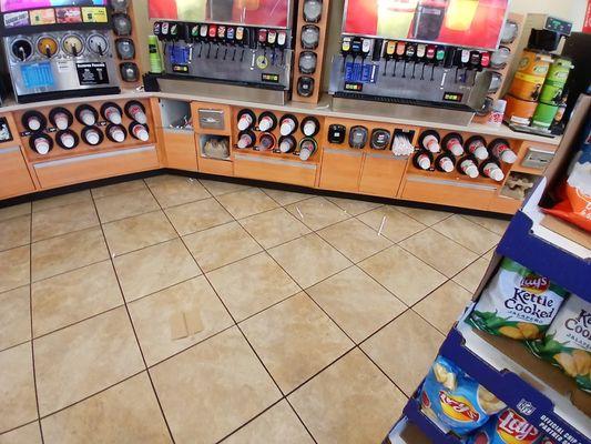 Beverage area.  Floor sticky and dirty.  At least they had straws and lids available.