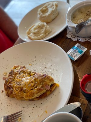 Meat lovers omelette w/grits & biscuit.