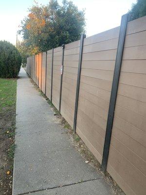 fence installation made of iron and horizontal wooden boards combination. Reseda.